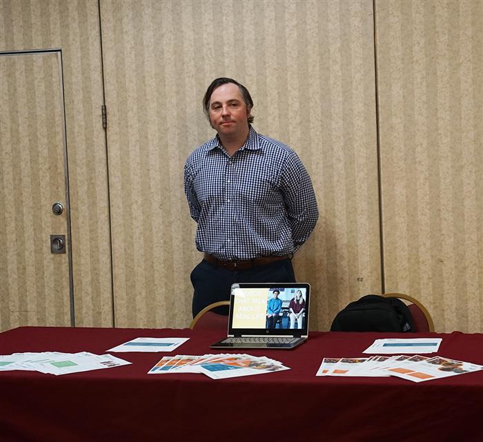 A SEL vendor stands behind his table at the AIU's SEL day.